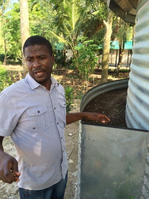 The silo base is anchored with rocks, then soil is added for a garden.