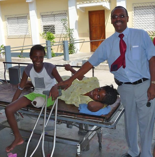 Dr. Leger with his first amputee patient and her adopted sister